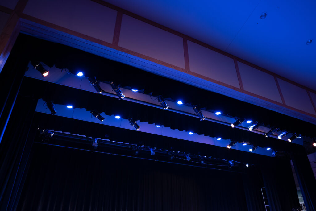 A Ceiling Of A Stage With Blue Lighting.