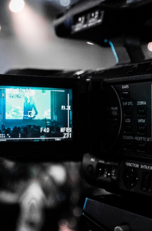 A Video Camera Screen Recording A Person Performing On A Stage.